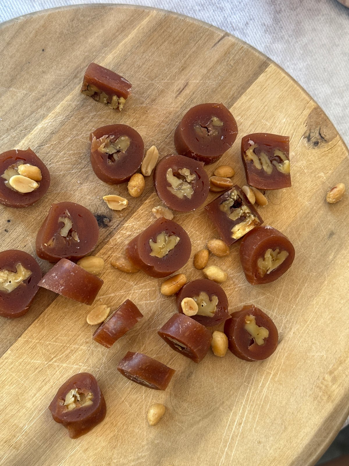 Dark candy pieces displayed on cutting board in Podgorica