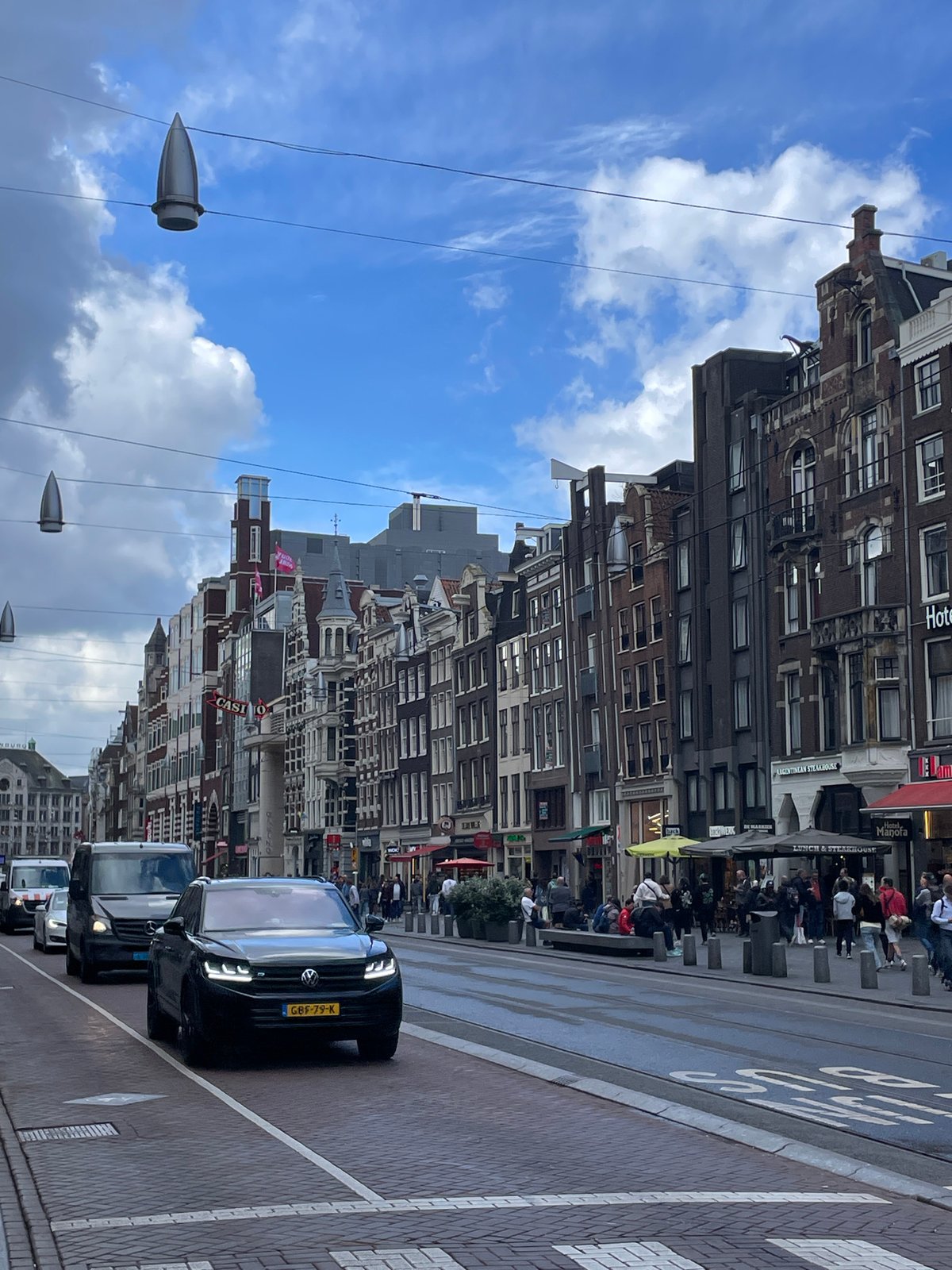 Swan family spotted in Amsterdam canals amid historic architecture