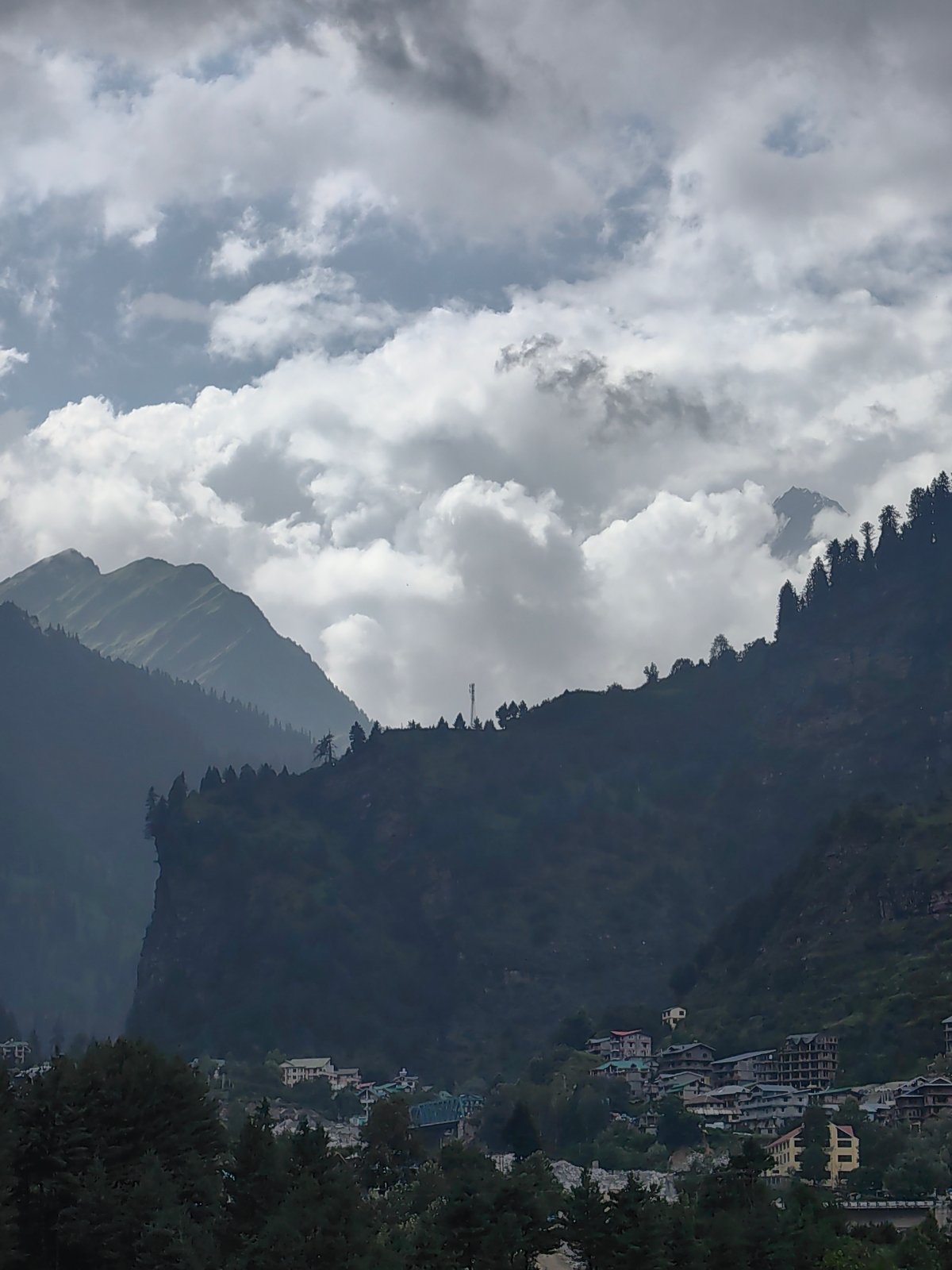 Kulang valley under monsoon clouds, river, villages, and construction