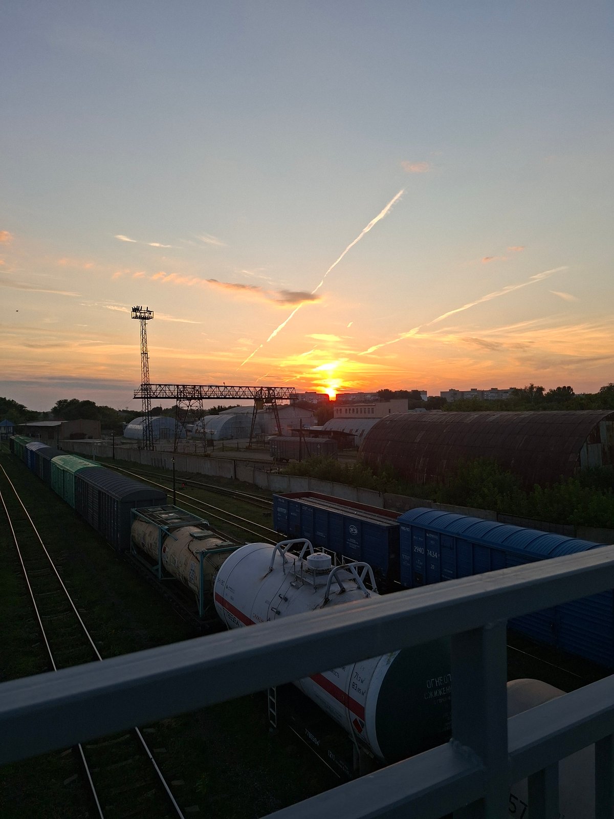 Sunset over Oral's freight yard, trains at rest
