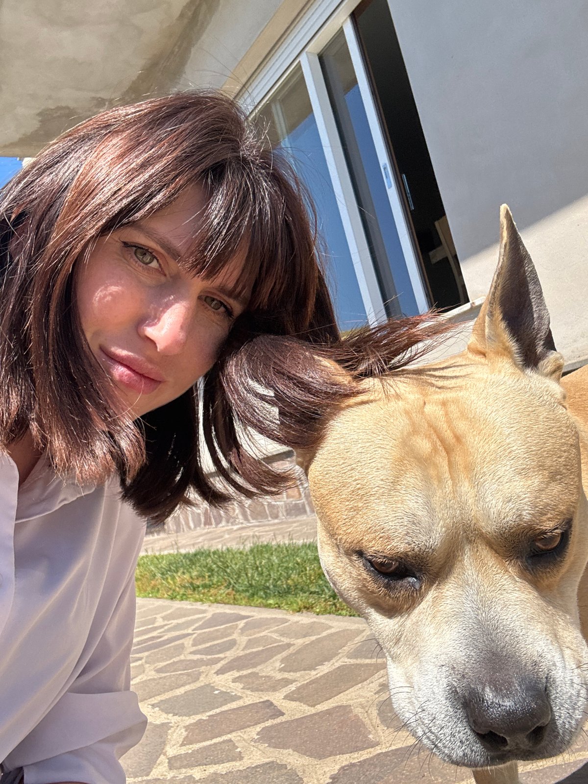 Woman and dog enjoy quiet morning moments in Aprilia backyard