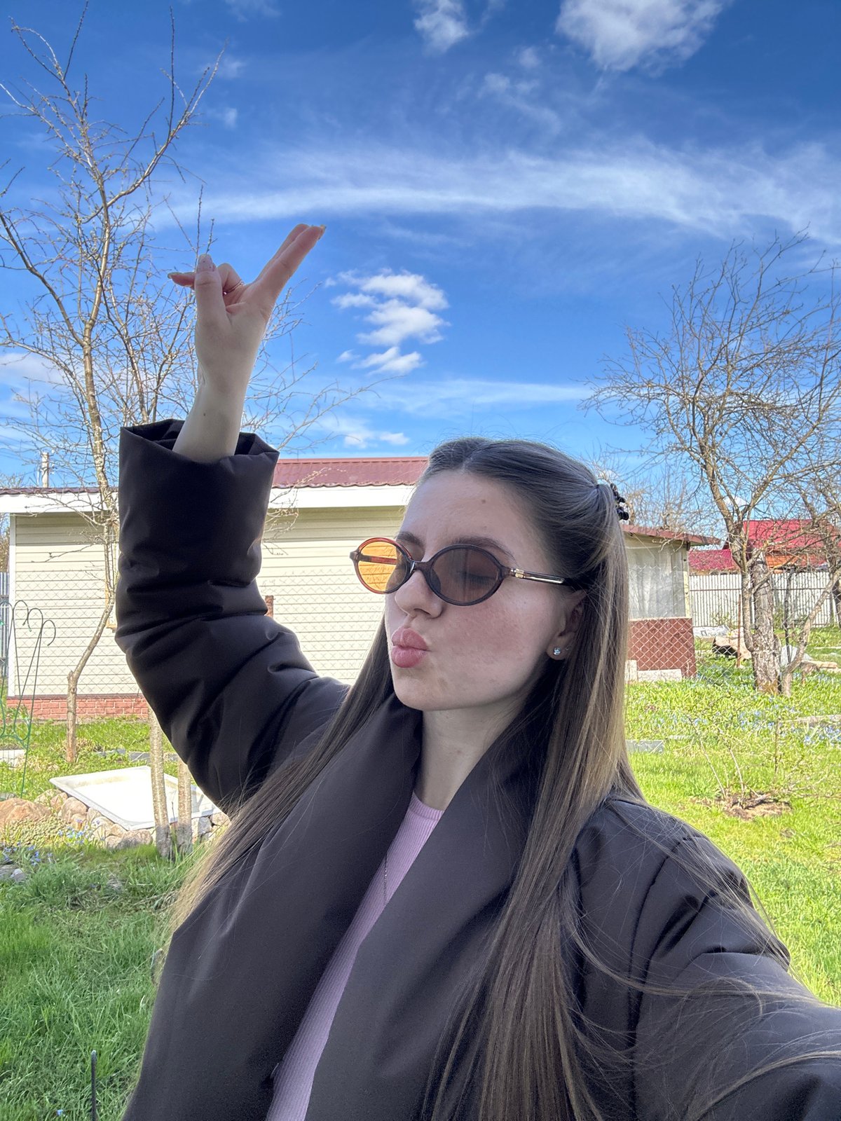 Woman poses for photos outside home in Klin, Russia