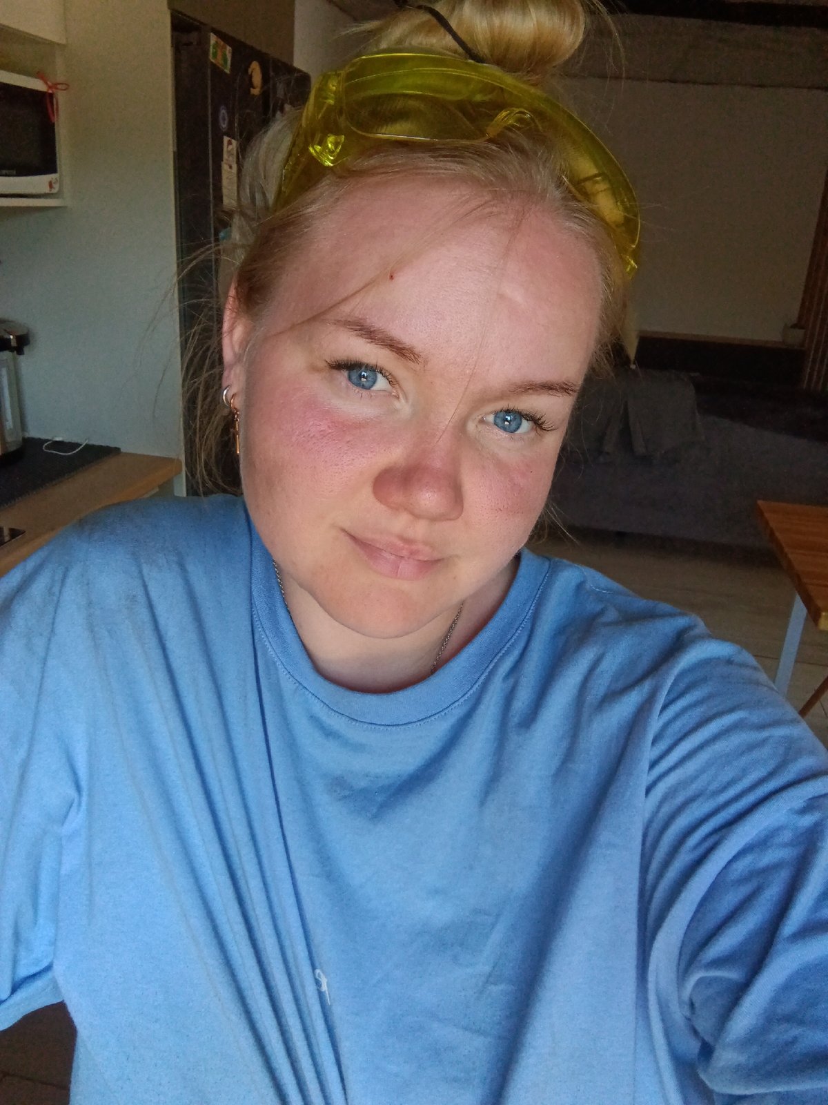 Woman takes kitchen selfie wearing yellow goggles in Russia