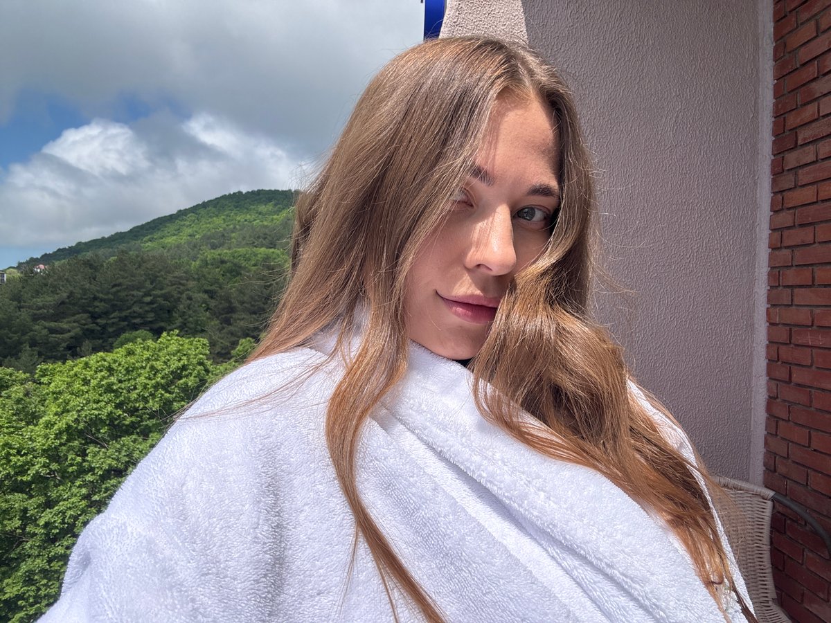 Woman in bathrobe spotted on balcony in Sosnovy, Russia
