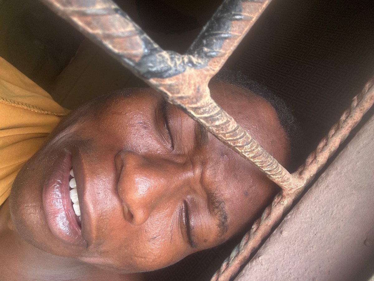 Person photographed making various expressions near metal bars