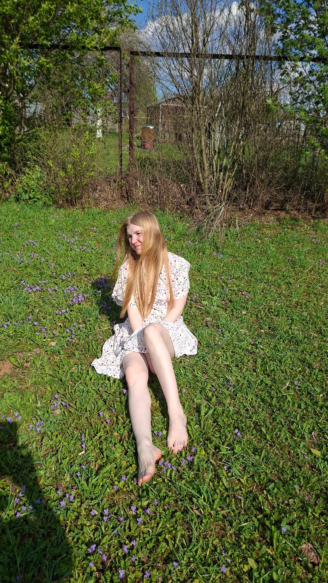 Woman relaxes in flower field in rural Russia