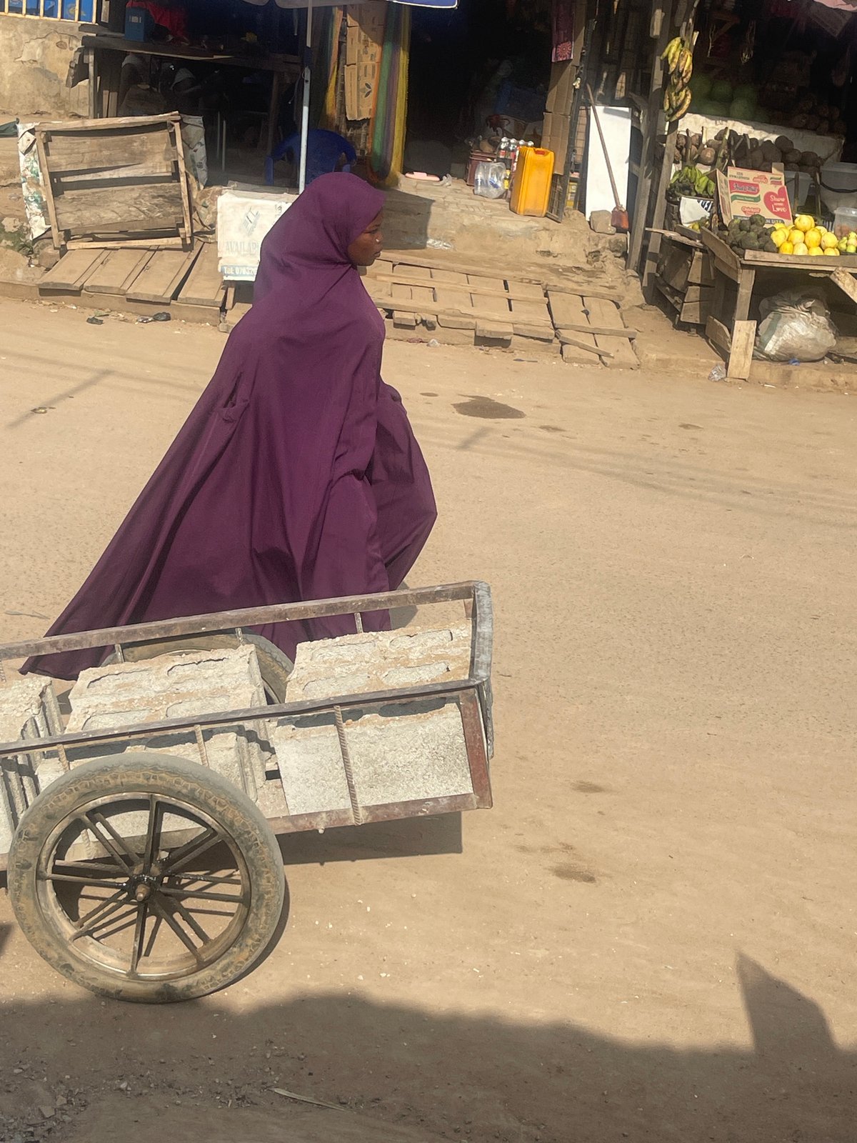 Everyday street and market life across Abuja's dusty midday roads