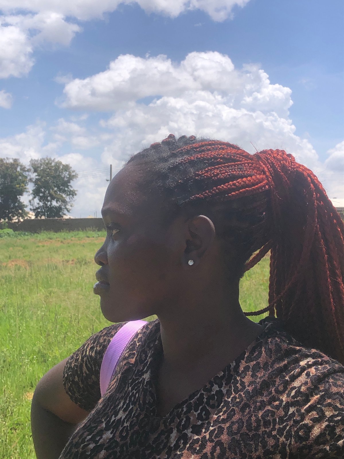 Shooting with a DSLR in a grassy field in Gwafan, Nigeria