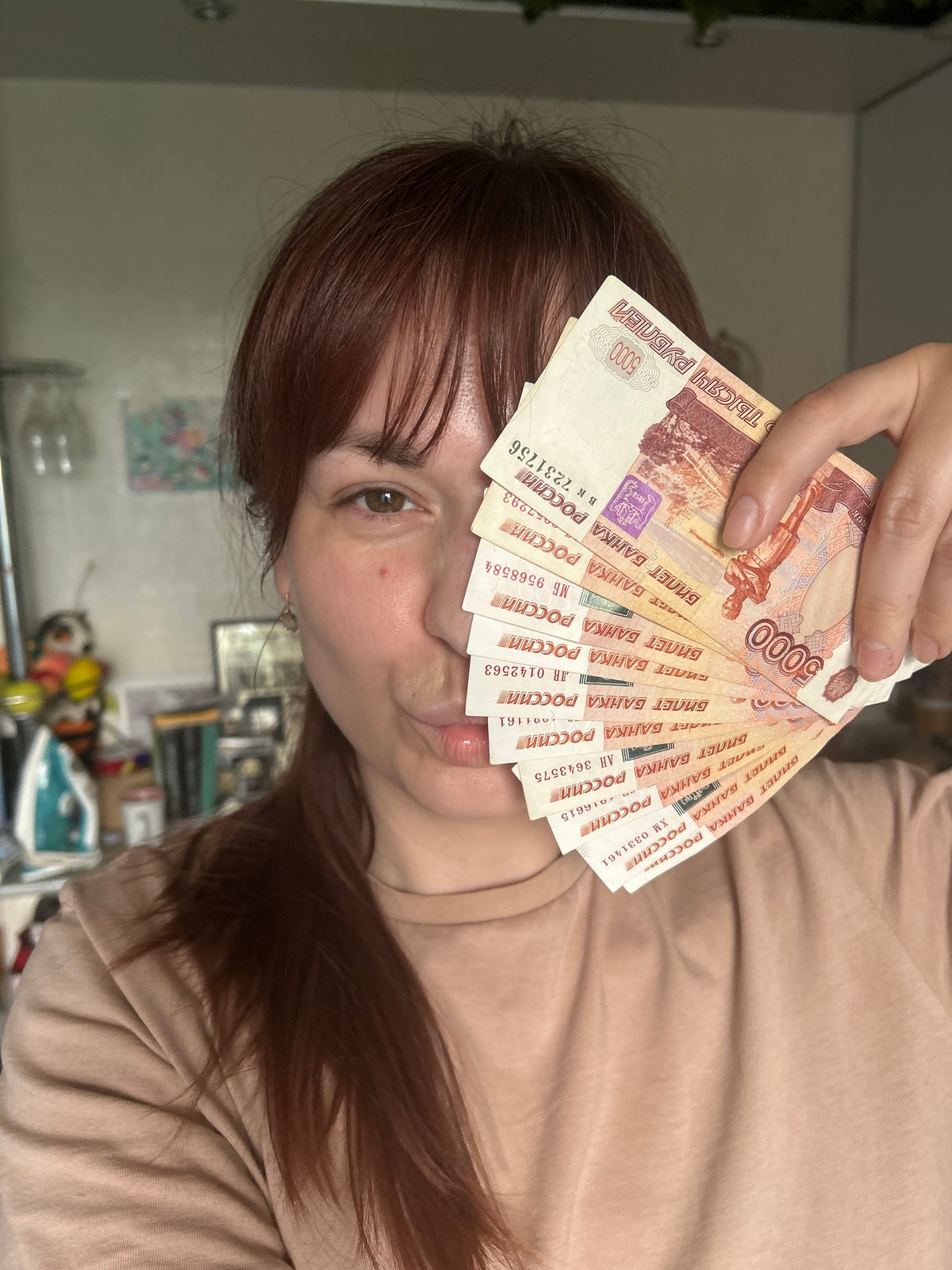 Woman photographed with cash, outdoors and indoors in Russia