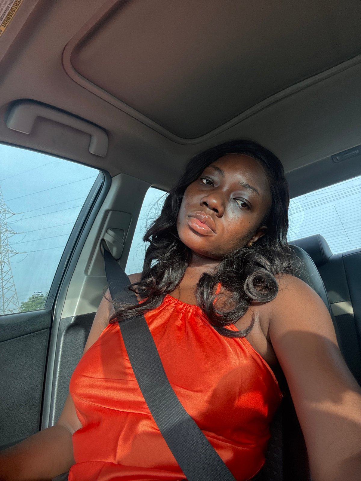 Woman in orange observed in vehicle, Kuchingoro Nigeria