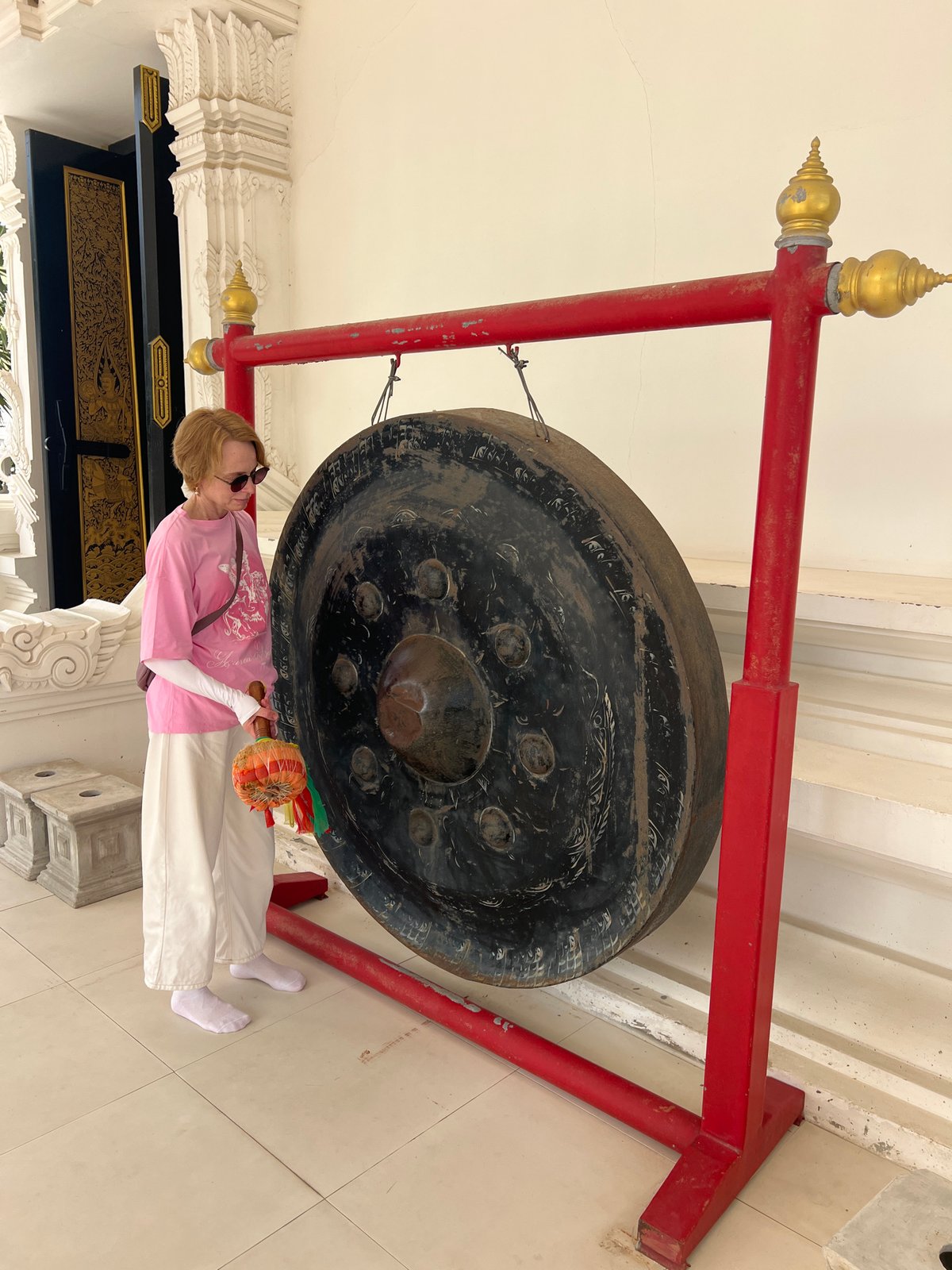 Temple visitors experience Buddhist rituals and sacred art in Thailand