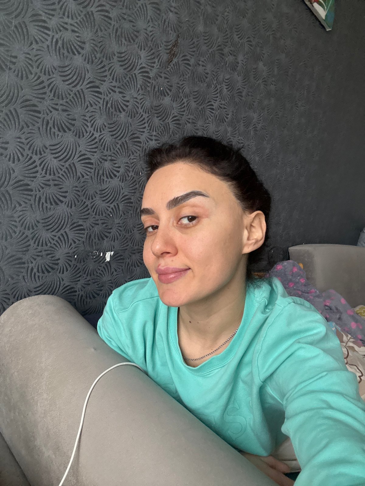 Woman takes casual indoor selfies in Tbilisi apartment