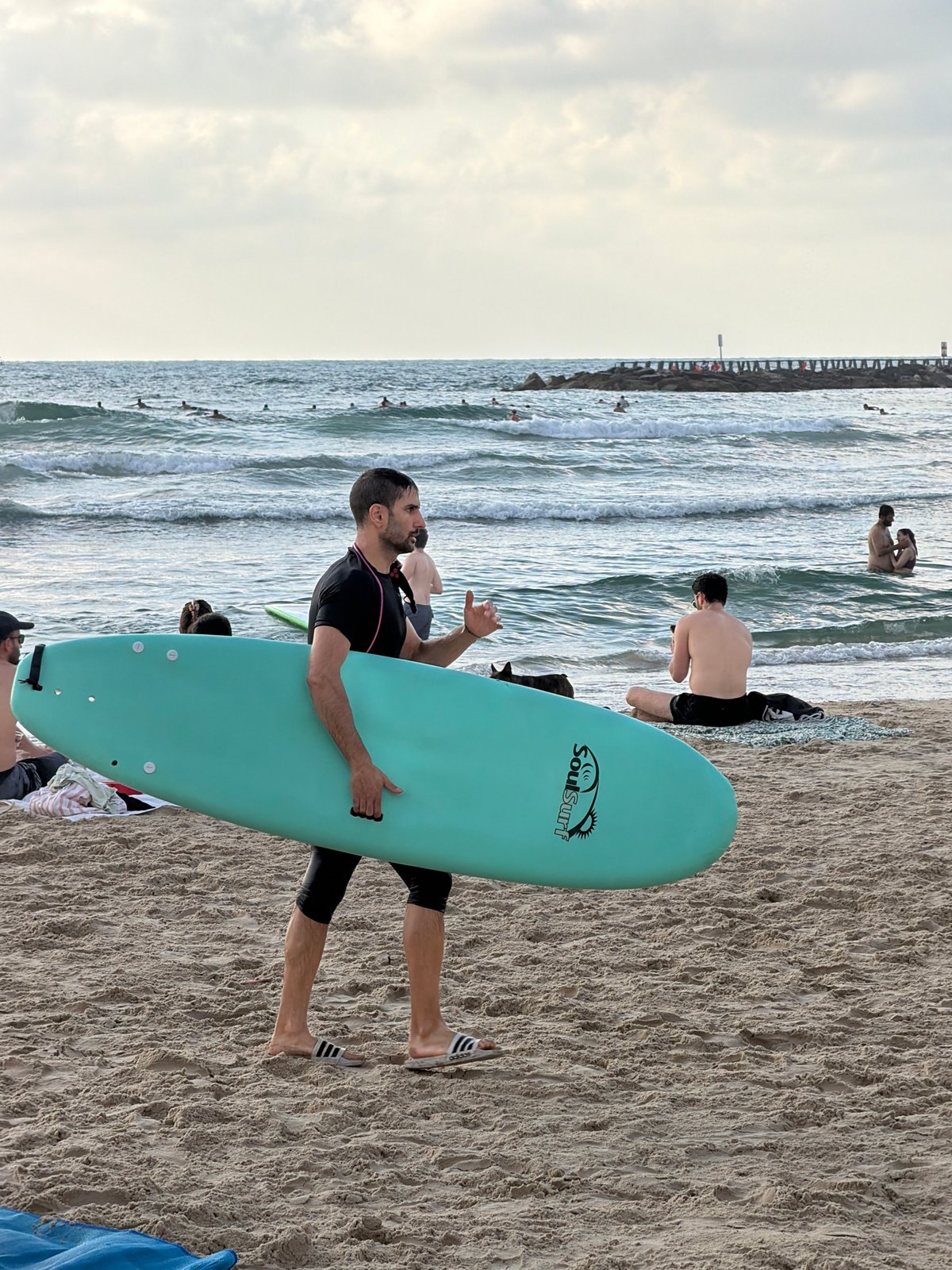Surfers, swimmers, and street life along Tel Aviv's beachfront