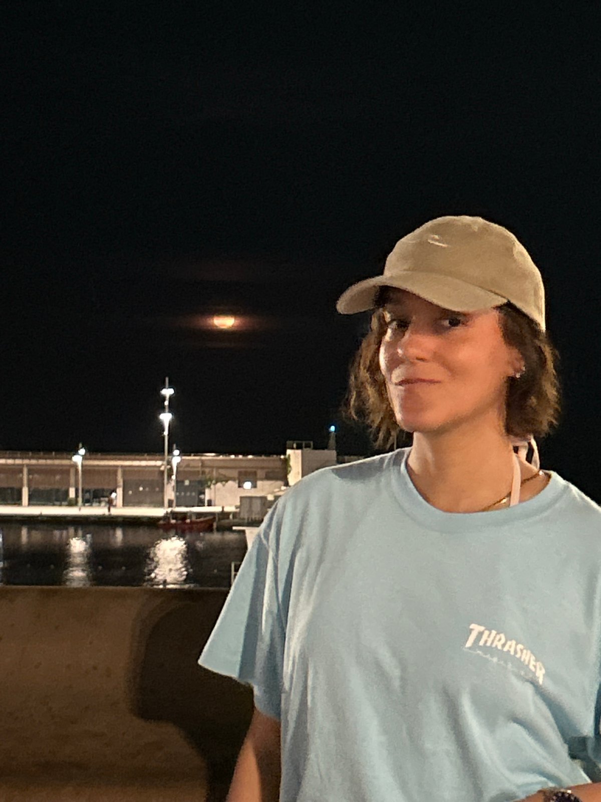 Person spotted at Barcelona waterfront near Torre Glòries at night
