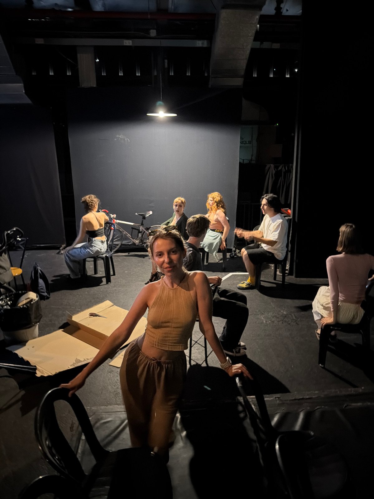 Theater group rehearses on a dim Tel Aviv stage with minimal set