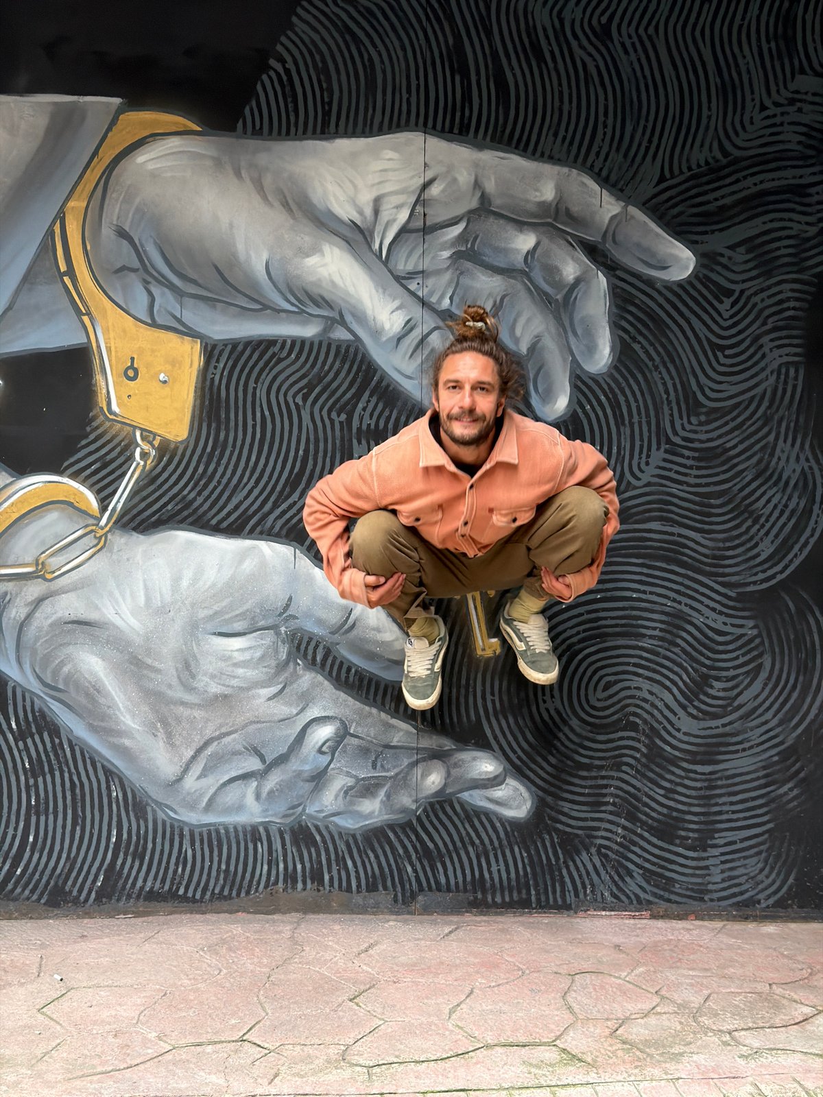 Man poses on street mural in Istanbul's Beyoğlu district