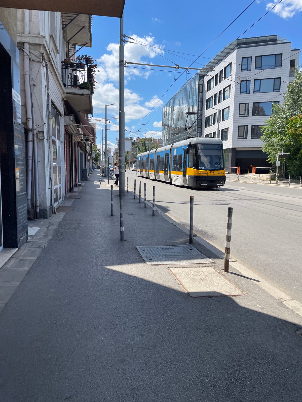 Blue tram rolling through sunny Sofia streets