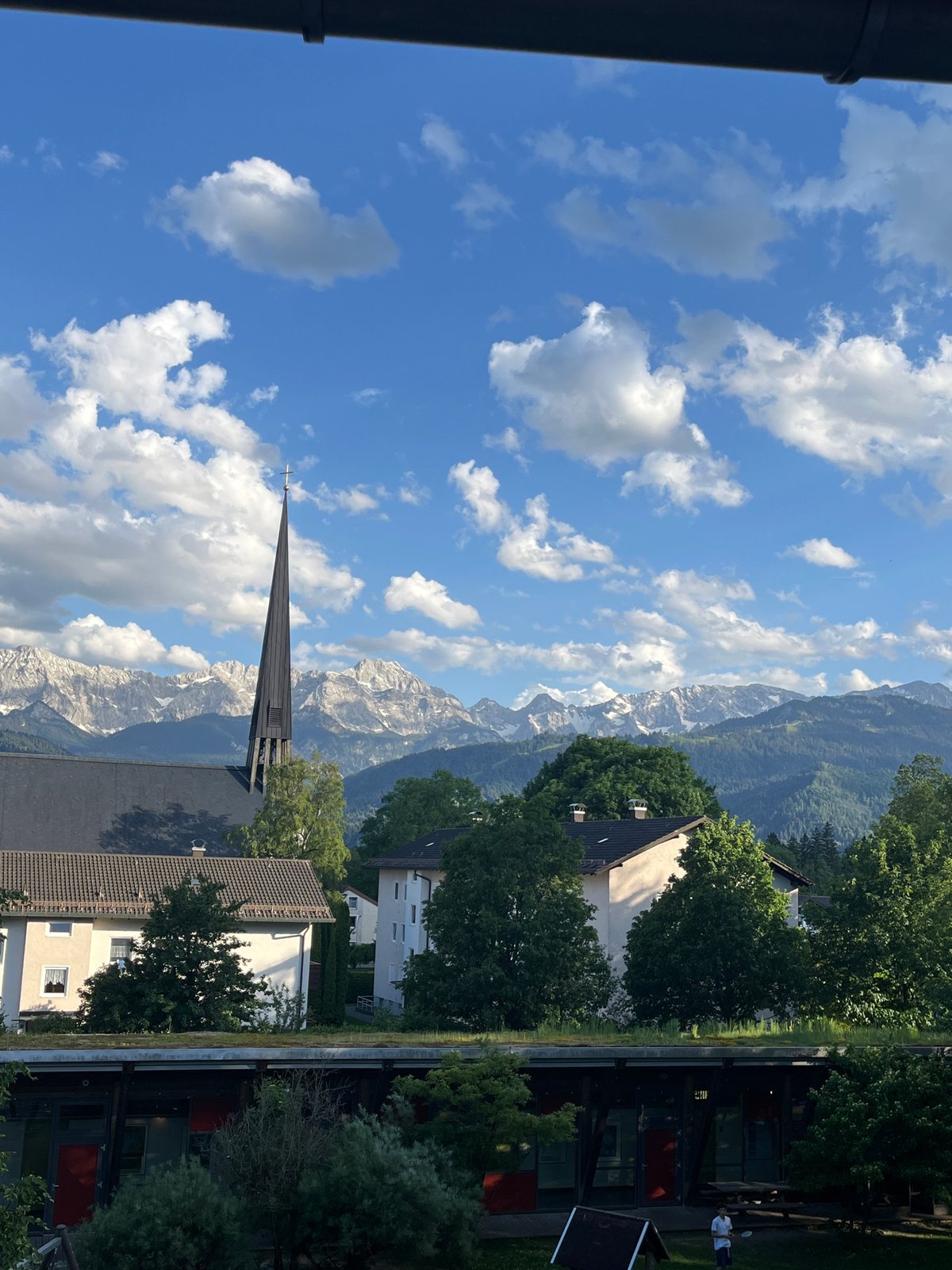 Church spire photographed against Bavarian Alps in Garmisch-Partenkirchen