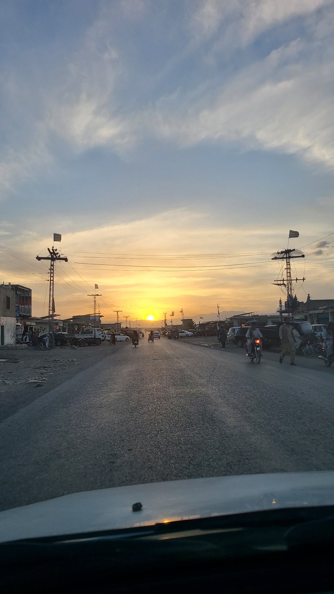 Sunset illuminates street scene in Qilla Saifullah, Pakistan