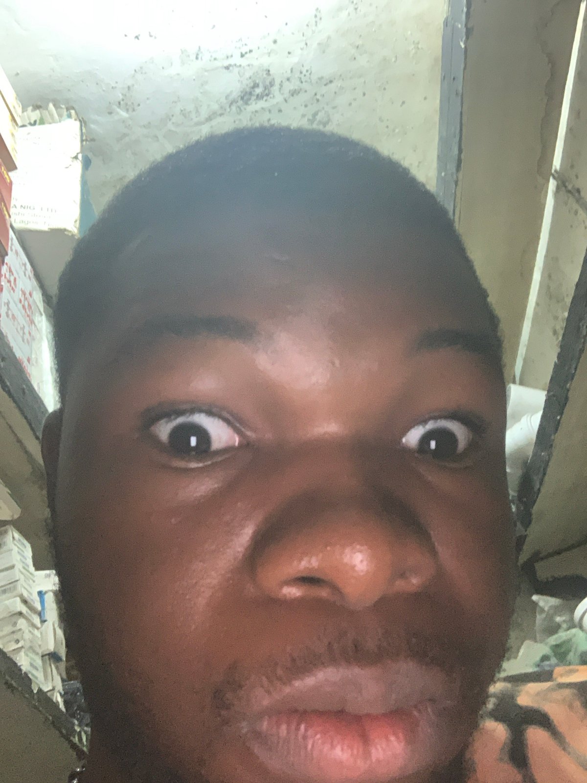 Portrait session documented at Nigerian pharmacy counter