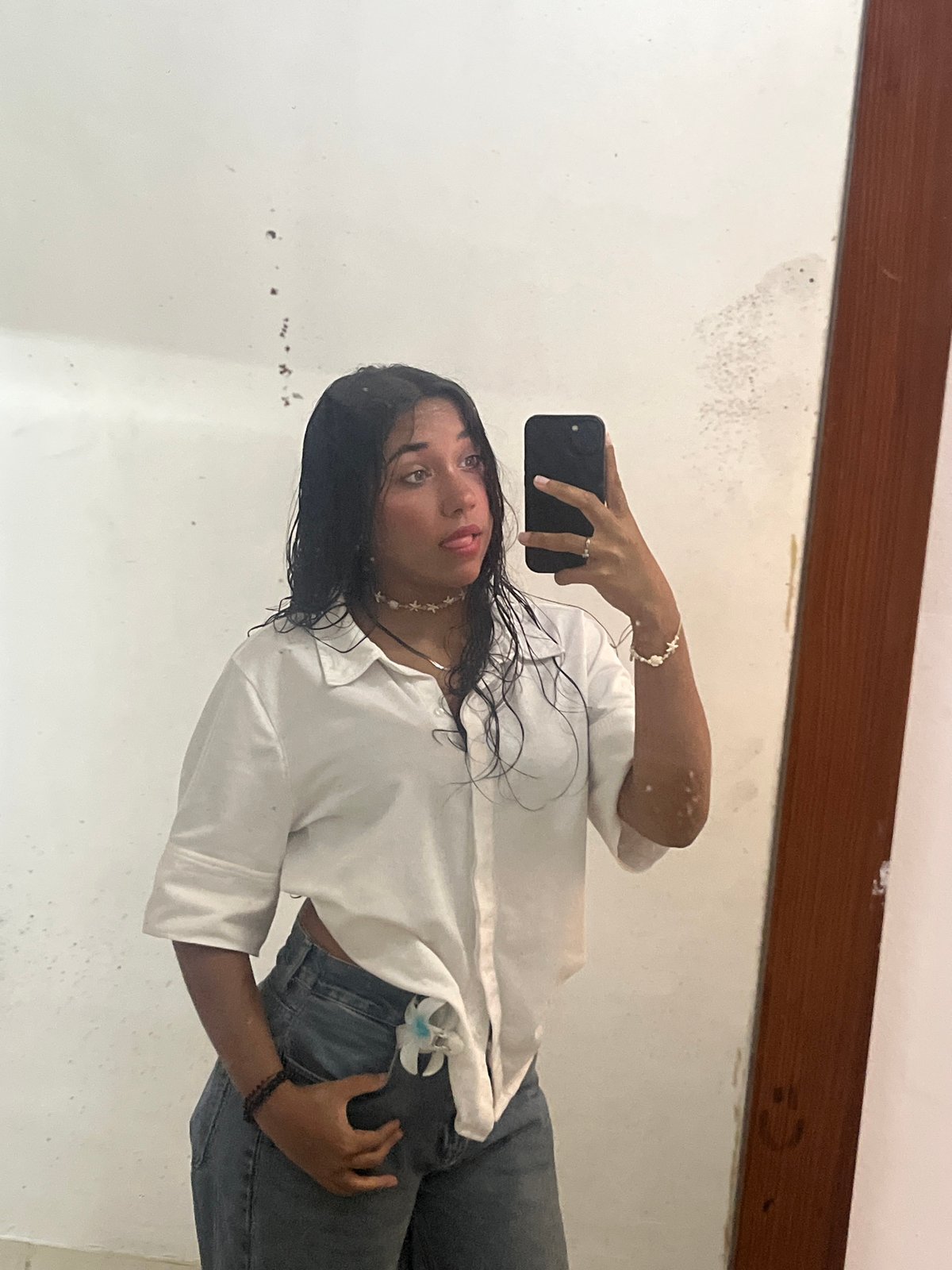 Woman takes mirror selfies in Pampatar, Venezuela bathroom