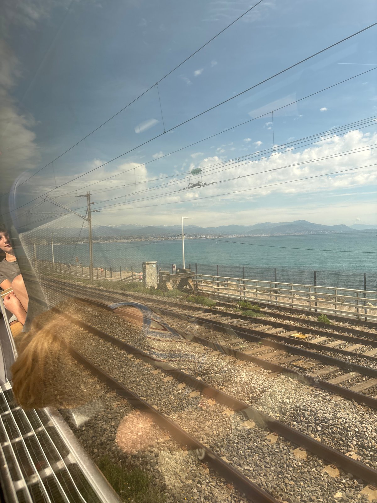 Train travels scenic coastal route in Antibes, France