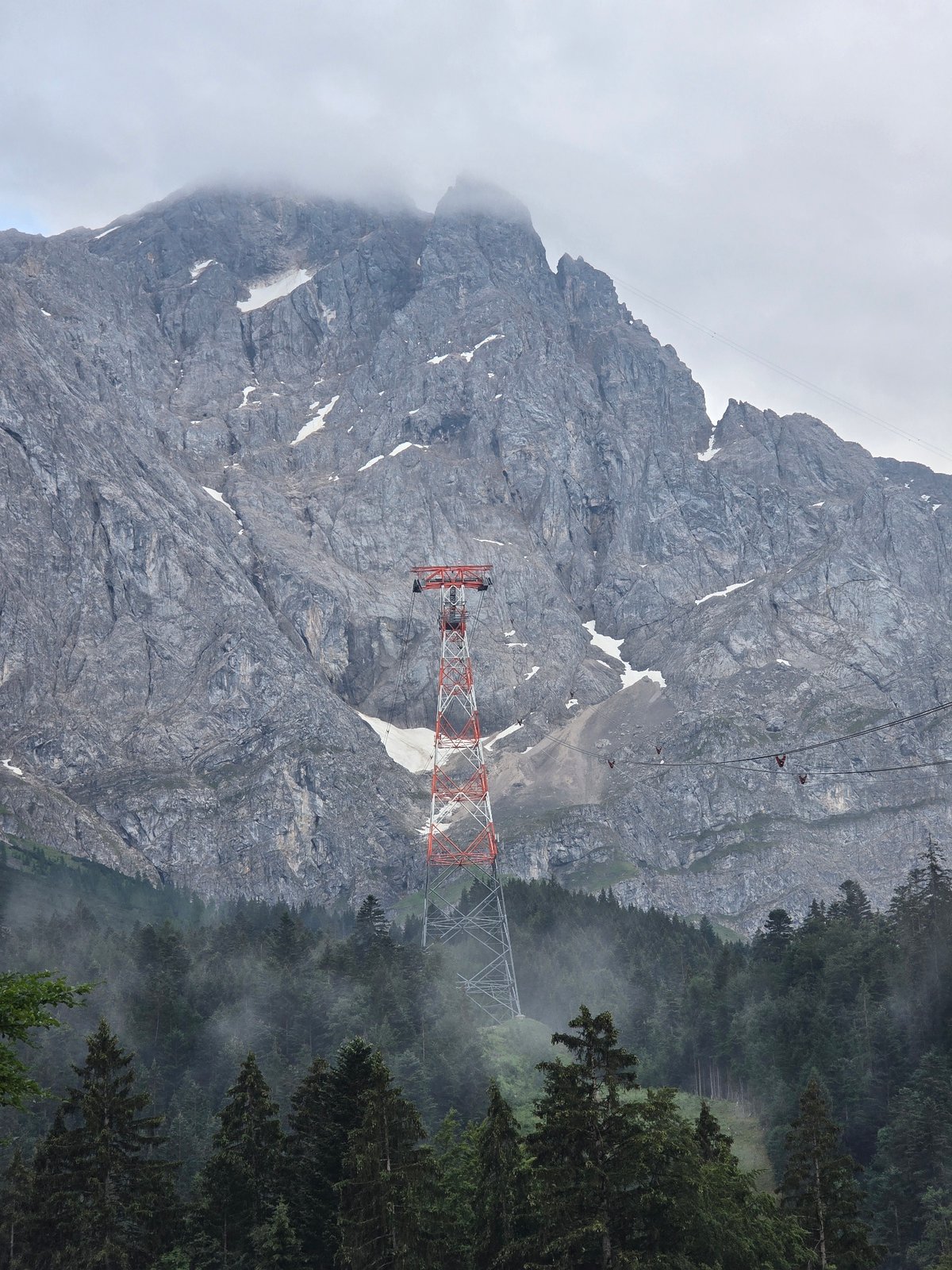 Eibsee at dawn: foggy lake, pine forest, Zugspitze cable car