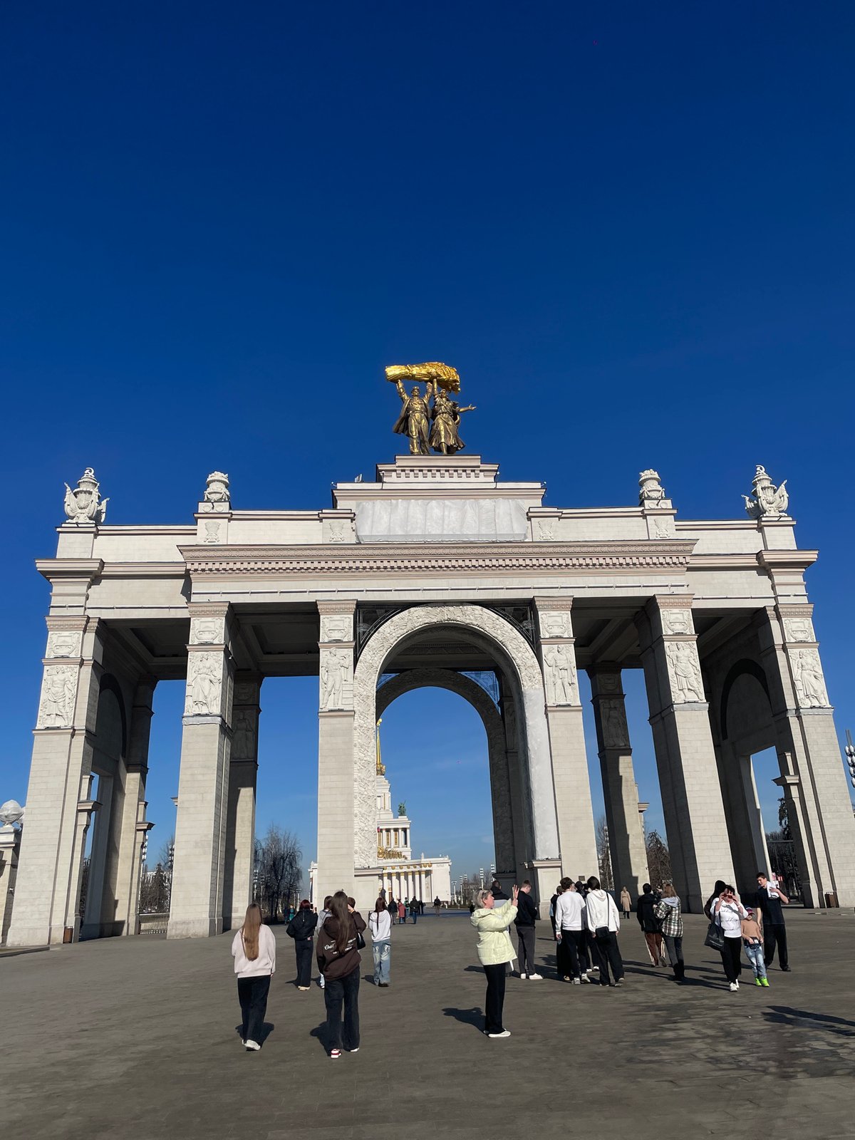 Women take selfie at monument in Khimki, Russia