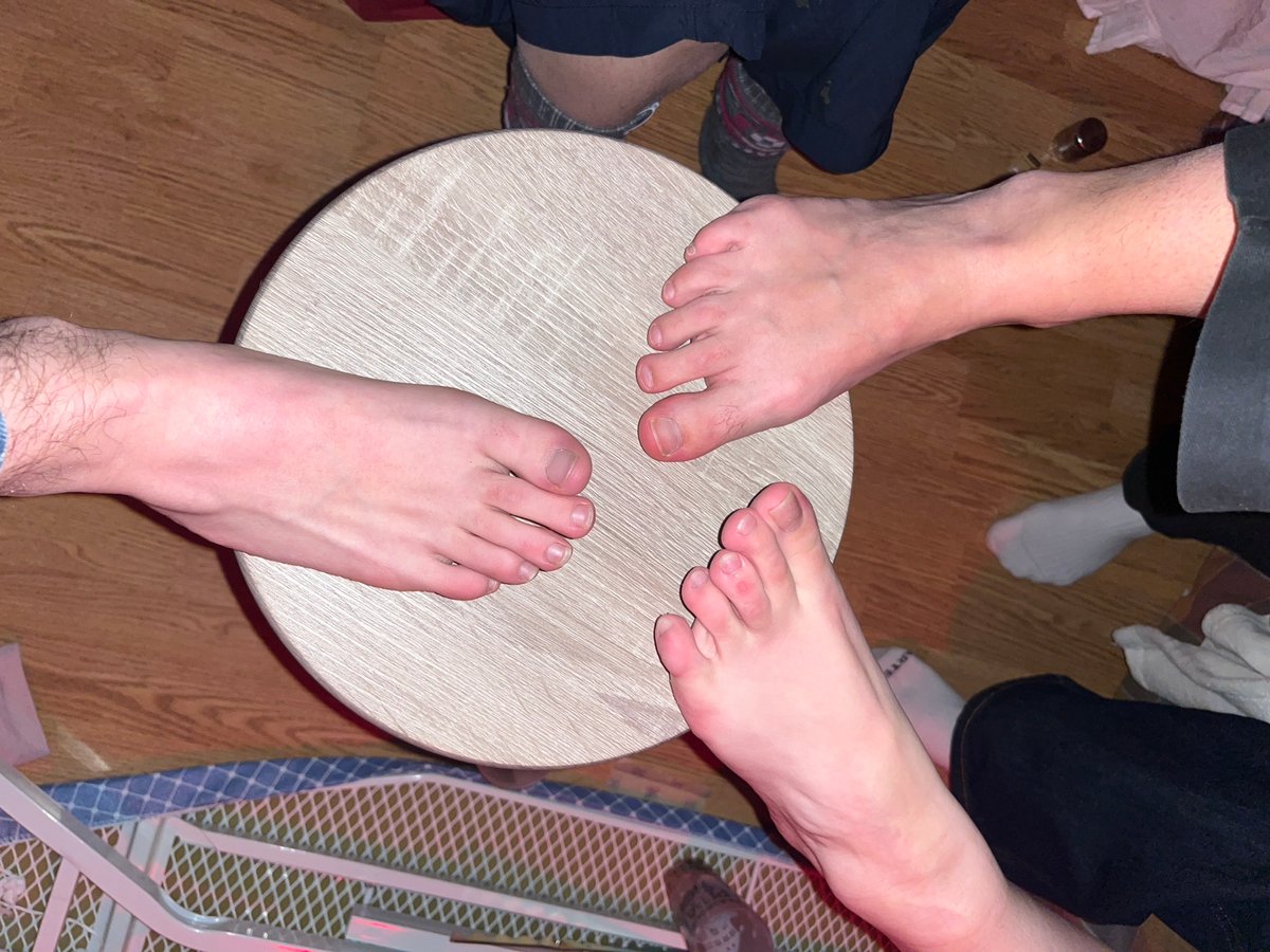 Three people gather barefoot around table in Strasbourg
