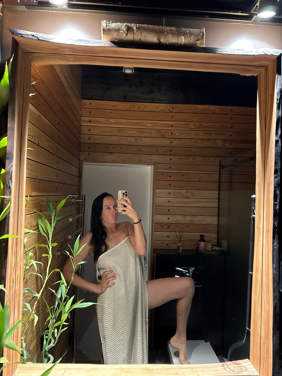 Mirror selfie in a wood-paneled bathroom, Chaikovsky