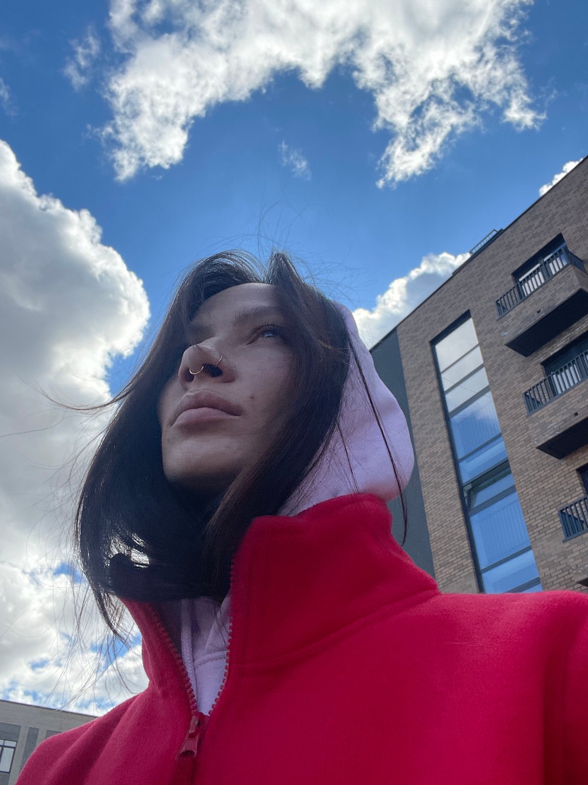 Woman in red hoodie photographed from below in Семёново