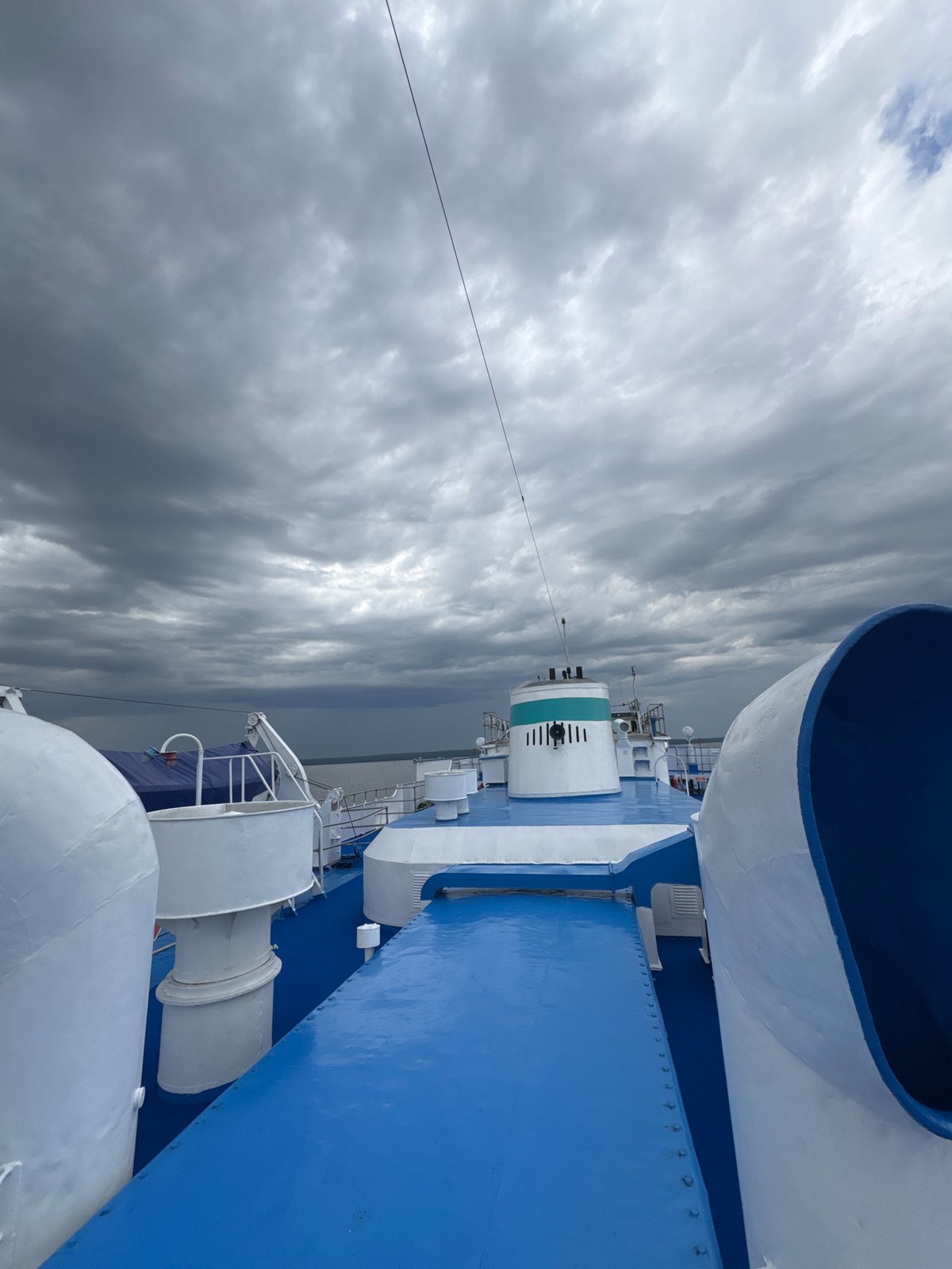 On the deck of a blue ferry at Икское Устье