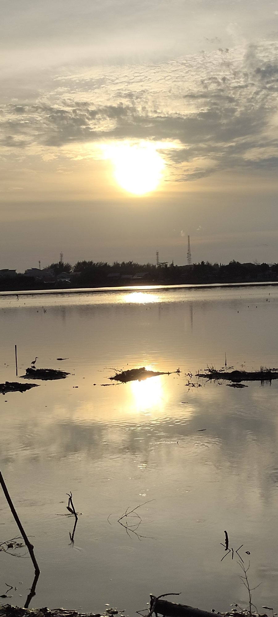 Golden hour along Lhokseumawe's reservoirs, rivers, and shoreline