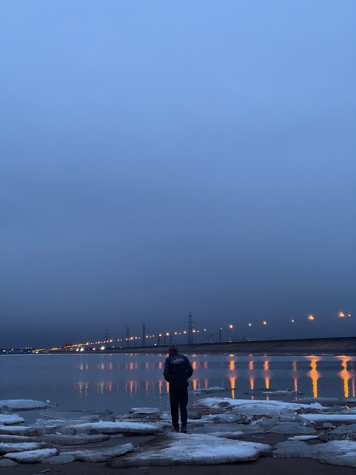 Twilight photography session captured at frozen waterfront in Noviy, Russia