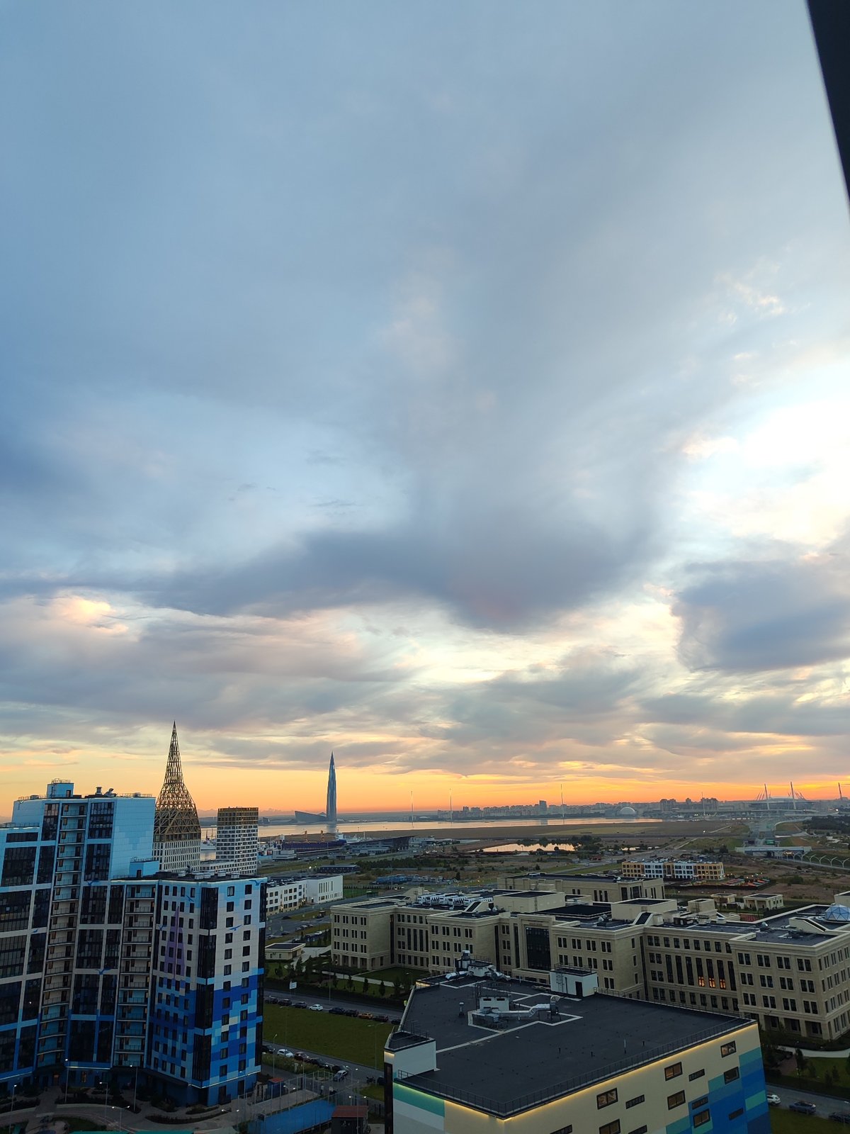 Saint Petersburg skyline glows under a cloudy summer sunset