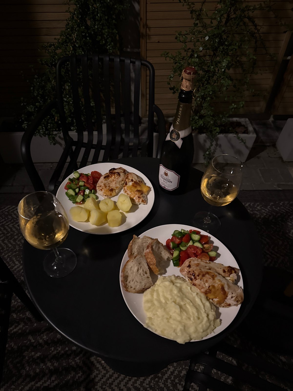 Cape Town dinner documented with chicken, wine on outdoor table