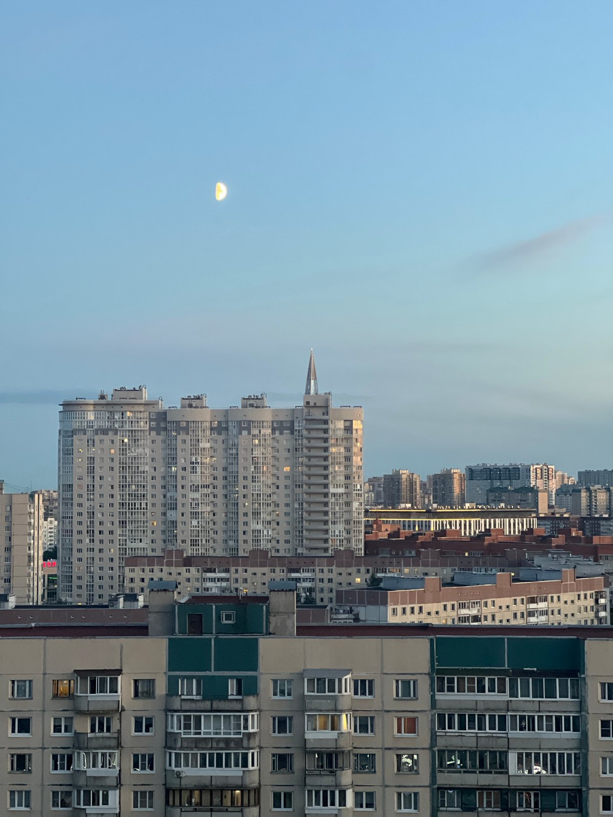 Crescent moon over beige apartment blocks in Saint Petersburg
