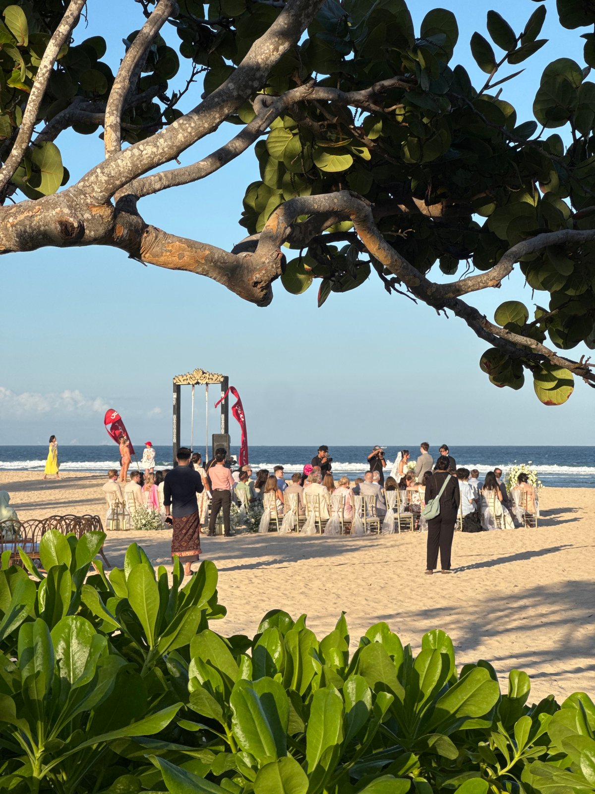 Beach wedding and watersports on a flagged Kuta Selatan shore