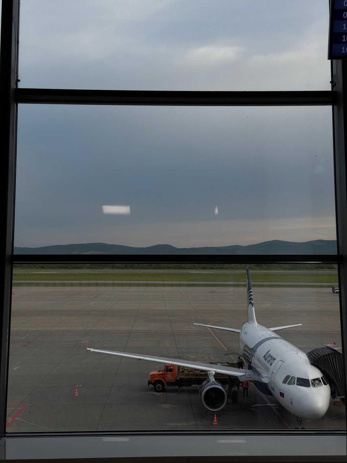 Traveler waits as Aurora aircraft services at Artyom Airport