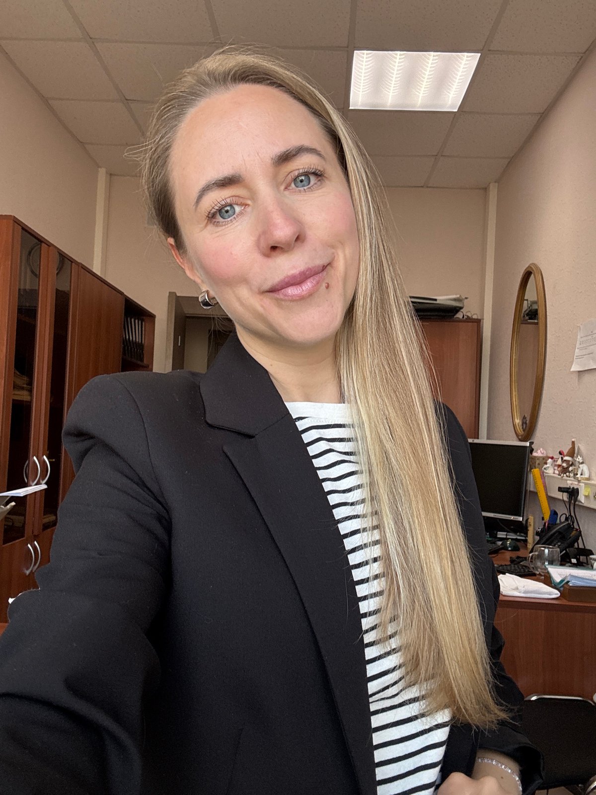 Woman takes selfie in Chaikovsky office early morning
