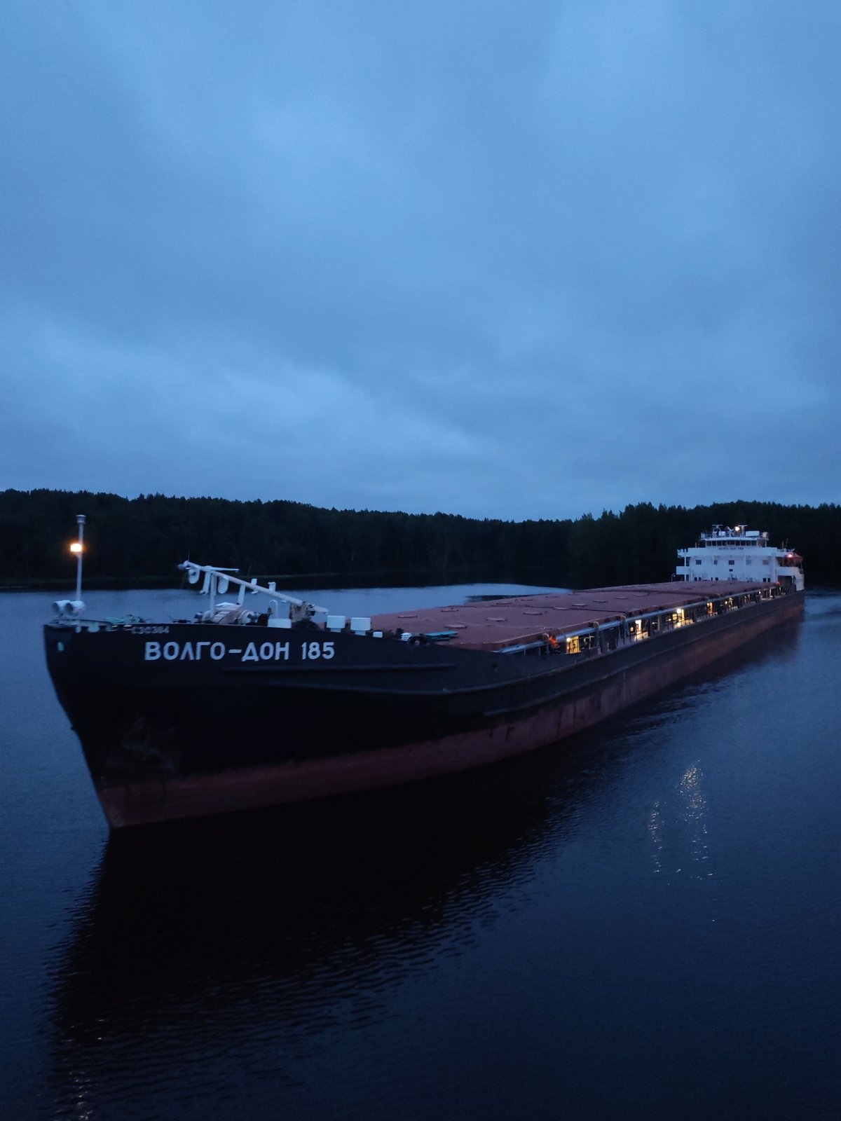 Cargo barge ВОЛГО-ДОН 185 transits a lock near Markovo at dusk