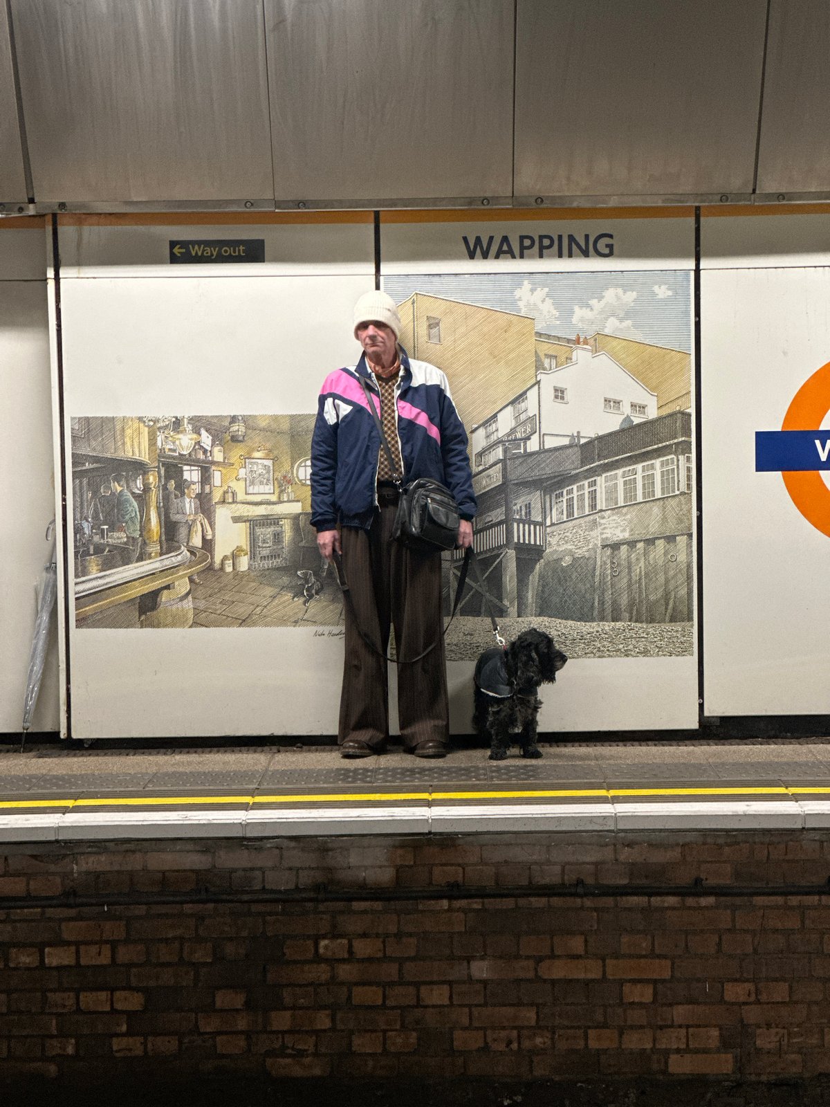 Person with small dog spotted at Wapping Underground station