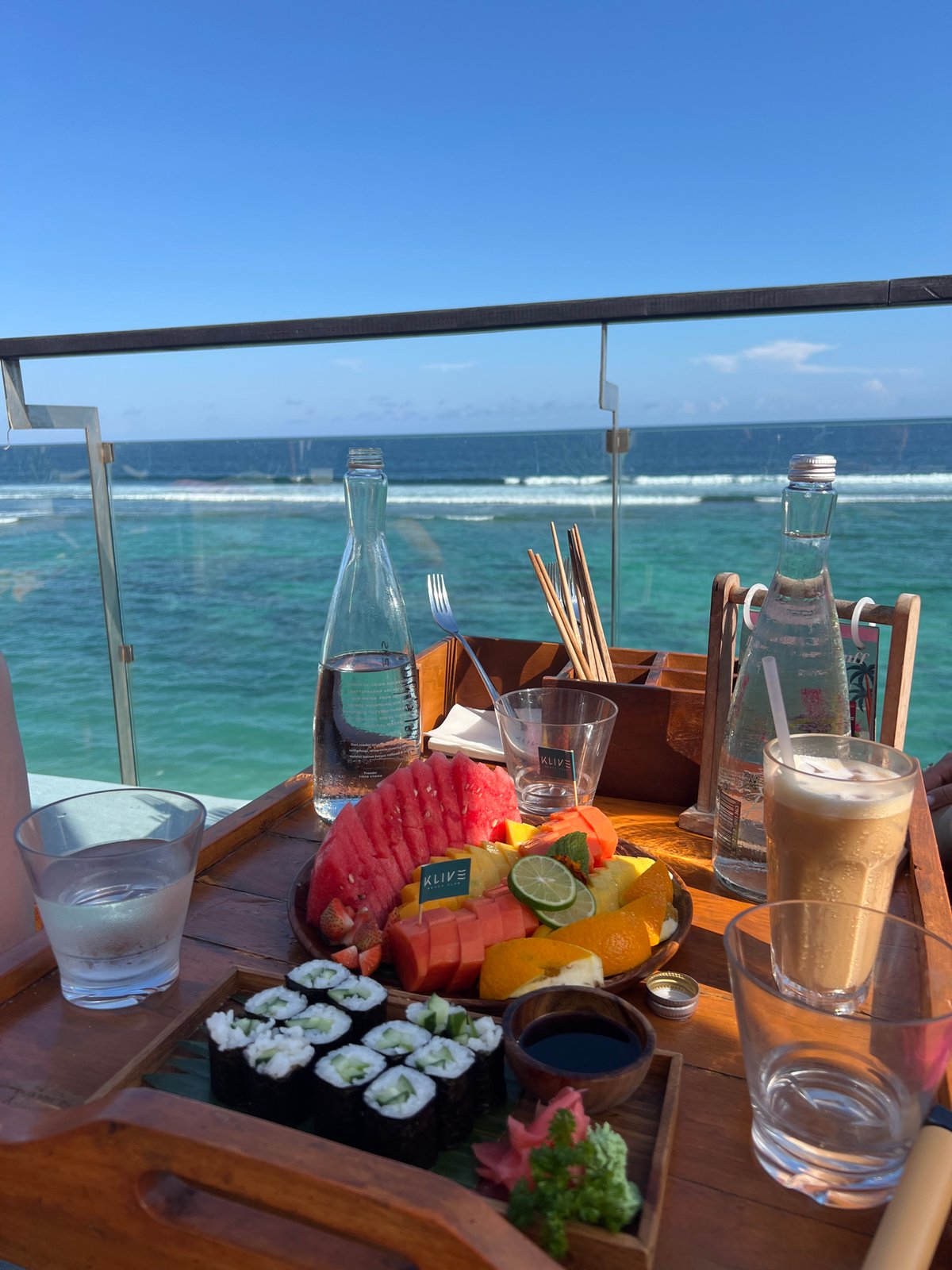 Beachside lounge area observed overlooking turquoise coastal waters