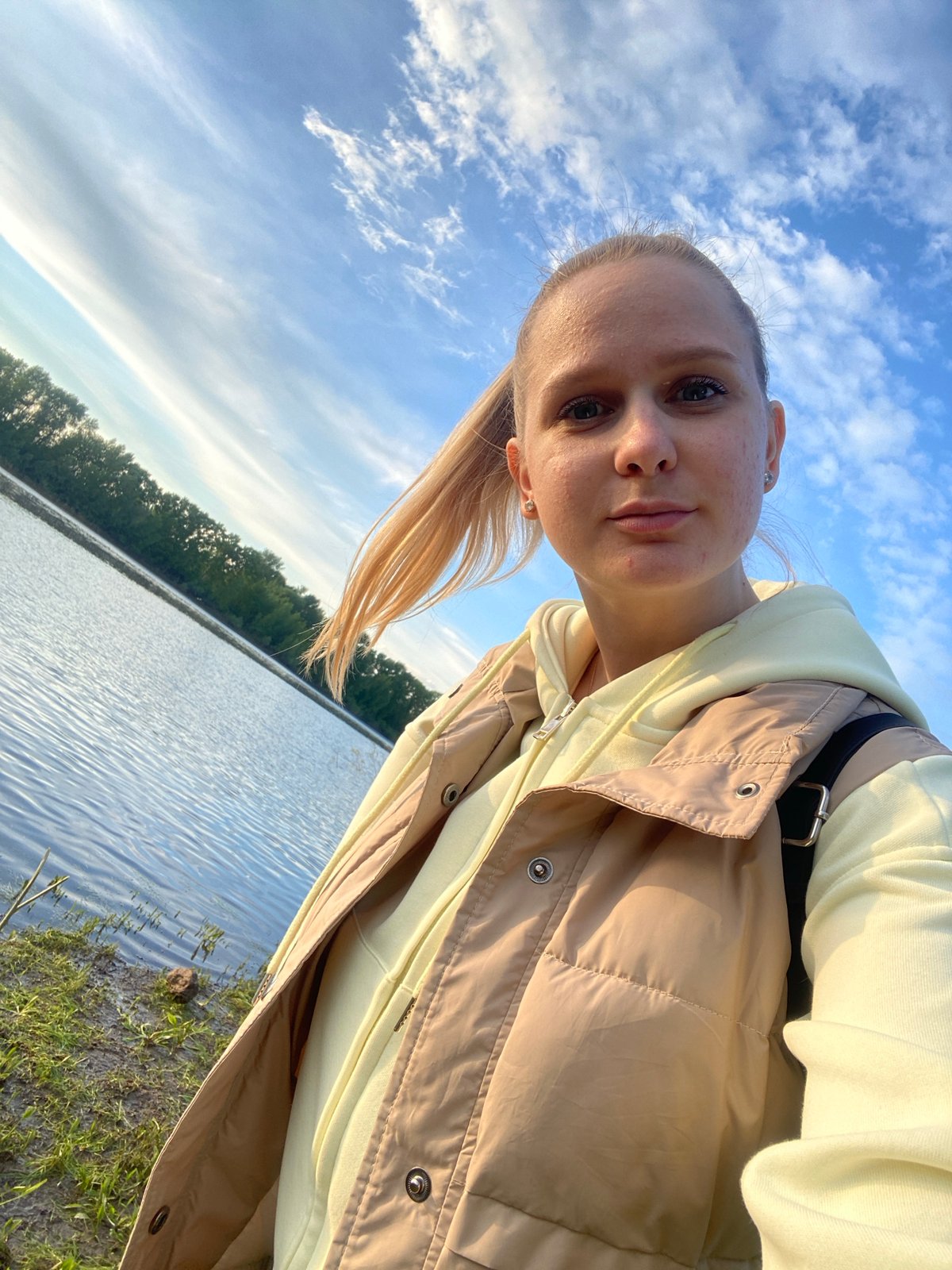 Woman poses for selfies by lake in Chaikovsky