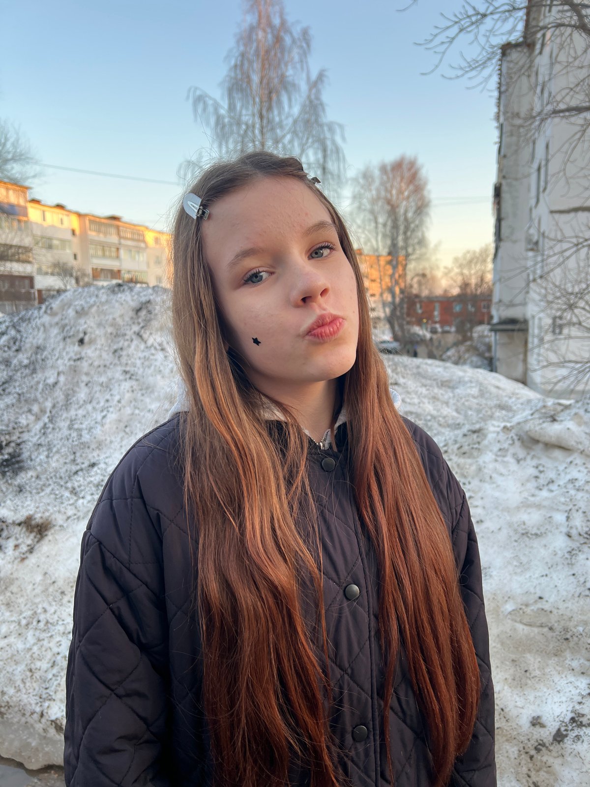 Children playing outdoors in snowy Noviy Urengoy residential area