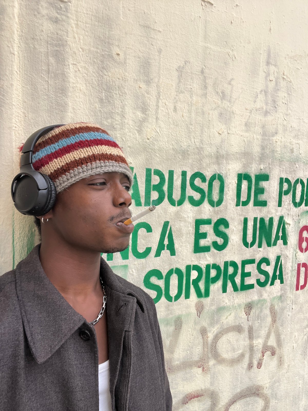 Young man rests against wall in Barcelona