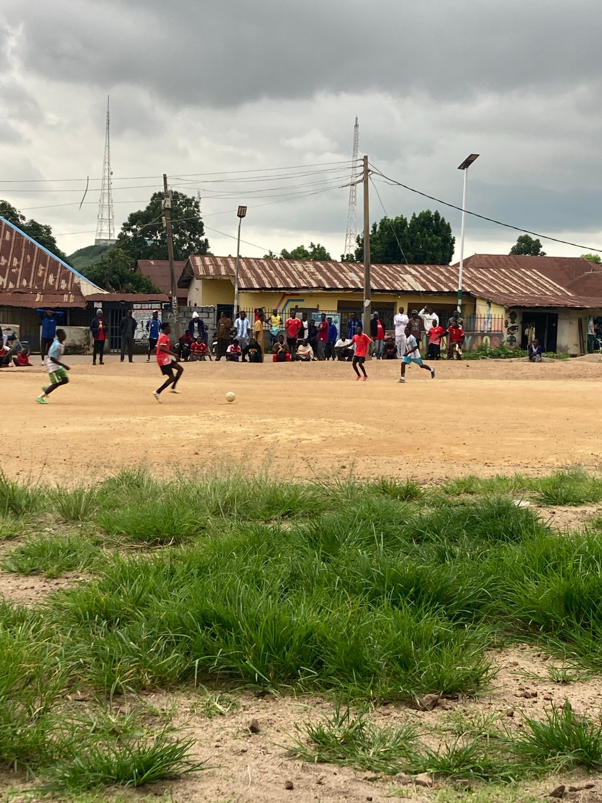 Pickup soccer on a dirt field in Jos, Nigeria
