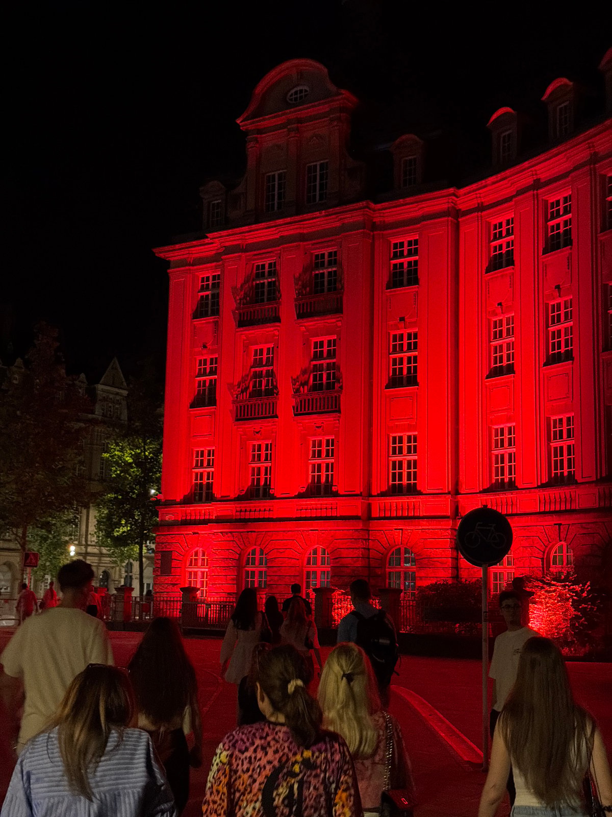 Historic Luxembourg building glows red on a summer night