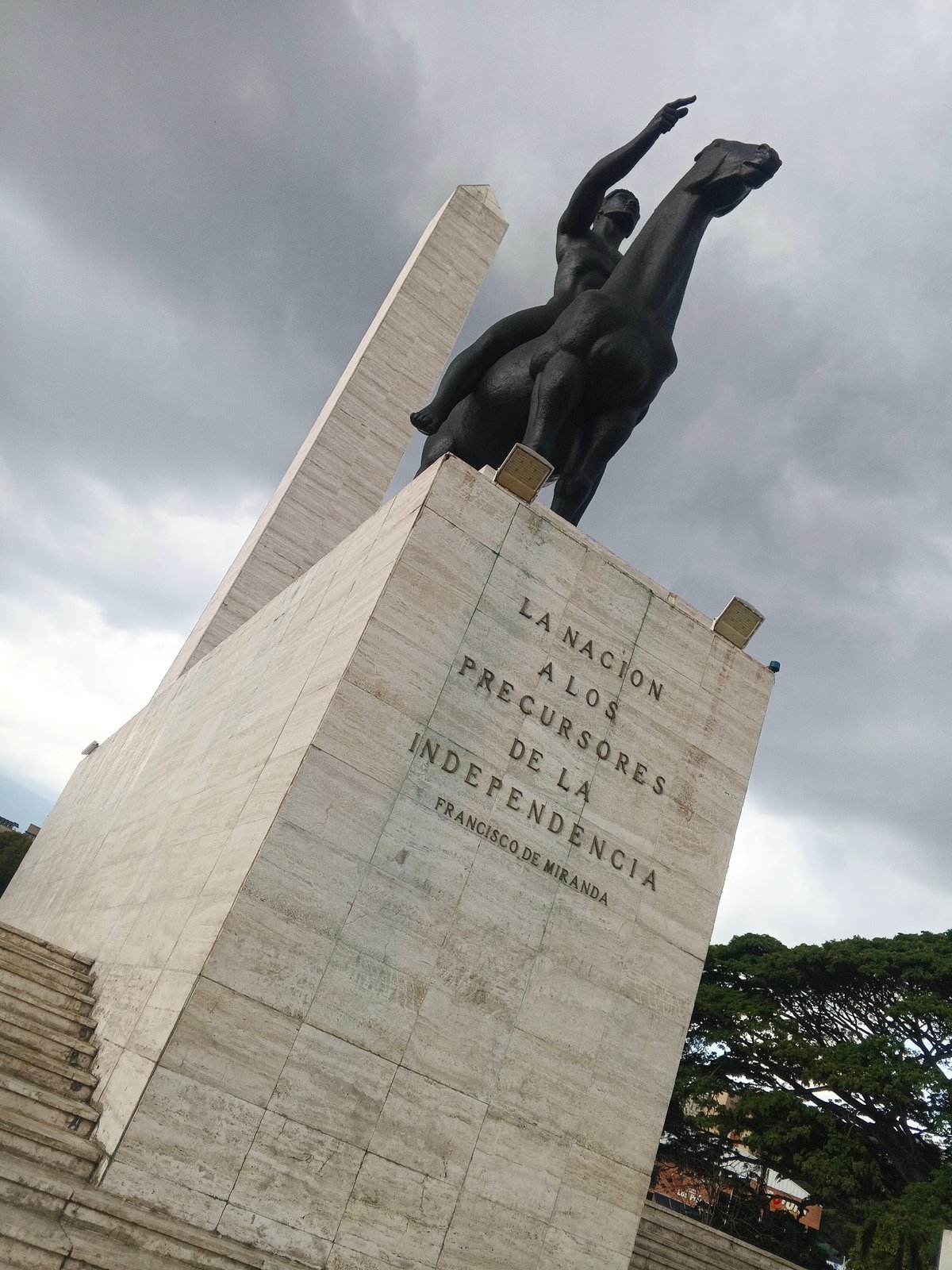 Park visitors document fountains and equestrian monument during evening hours