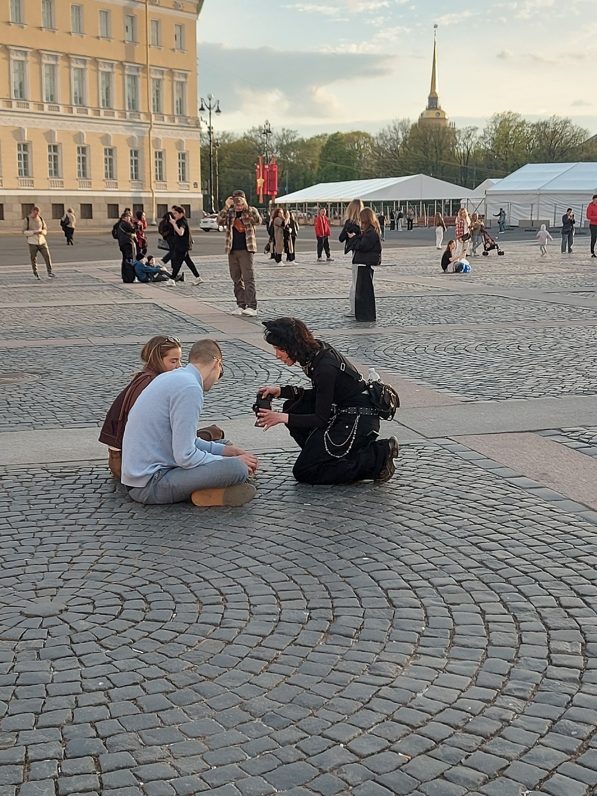 Street performer, couples gather in Saint Petersburg's Palace Square